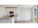 Bright kitchen features a center island, stainless appliances, and tile flooring at 2365 White Tail St, Davenport, FL 33837