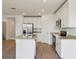 Bright kitchen features a center island, stainless appliances, and tile flooring at 2365 White Tail St, Davenport, FL 33837