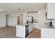 Bright kitchen features a center island, stainless appliances, and tile flooring at 2365 White Tail St, Davenport, FL 33837