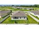 Aerial view of fenced backyard and home exterior surrounded by green lawn at 24401 Sunnys Halo Way, Sorrento, FL 32776