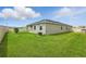 View of the backyard featuring a well-manicured lawn and white vinyl fence at 24401 Sunnys Halo Way, Sorrento, FL 32776