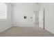 Bedroom with carpet, large window, and open door with tv mount and hookup at 24401 Sunnys Halo Way, Sorrento, FL 32776