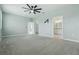 Spacious main bedroom featuring plush carpet, ceiling fan, and ensuite bathroom at 24401 Sunnys Halo Way, Sorrento, FL 32776