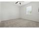 Neutral carpeted bedroom with a ceiling fan and a window with blinds at 24401 Sunnys Halo Way, Sorrento, FL 32776