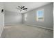 Spacious bedroom features carpet, ceiling fan, and natural light from windows at 24401 Sunnys Halo Way, Sorrento, FL 32776