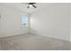 Neutral carpeted bedroom with a ceiling fan and a window with blinds at 24401 Sunnys Halo Way, Sorrento, FL 32776