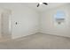 Bright bedroom with carpet, fan, and window showing exterior neighborhood at 24401 Sunnys Halo Way, Sorrento, FL 32776