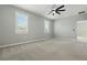 Bright bedroom with carpet, ceiling fan, and natural light from shuttered windows at 24401 Sunnys Halo Way, Sorrento, FL 32776