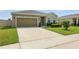 Charming single-story home with well-manicured landscaping and a two-car garage at 24401 Sunnys Halo Way, Sorrento, FL 32776