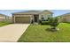 Inviting single-story home with a stone-accented facade, two-car garage, and green lawn at 24401 Sunnys Halo Way, Sorrento, FL 32776