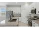 Bright kitchen features granite counters, stainless steel appliances, and white cabinets at 24401 Sunnys Halo Way, Sorrento, FL 32776