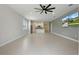 Open-concept living room with tile flooring and kitchen view perfect for entertaining at 24401 Sunnys Halo Way, Sorrento, FL 32776