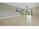 Spacious living area with tile floors, sliding glass doors to the backyard, and neutral wall color at 24401 Sunnys Halo Way, Sorrento, FL 32776