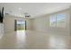 Bright living room featuring tile floors, a sliding glass door, and large windows for ample light at 24401 Sunnys Halo Way, Sorrento, FL 32776