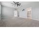 Spacious main bedroom featuring plush carpet, ceiling fan, and ensuite bathroom at 24401 Sunnys Halo Way, Sorrento, FL 32776