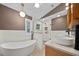 Modern bathroom with a soaking tub, glass-enclosed shower, and dual vanities at 2592 Westminster Ter, Oviedo, FL 32765