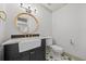 Stylish bathroom features a round mirror, apron sink, and unique patterned tile floor at 2592 Westminster Ter, Oviedo, FL 32765