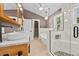 Bathroom featuring dual sinks, soaking tub, glass shower, and modern fixtures at 2592 Westminster Ter, Oviedo, FL 32765