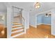 Welcoming entryway with hardwood floors and staircase to the upper level at 2592 Westminster Ter, Oviedo, FL 32765