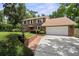 Charming two-story brick home boasts a manicured front yard and attached two-car garage at 2592 Westminster Ter, Oviedo, FL 32765