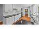 Modern kitchen features white cabinets and stainless steel appliances with black countertops at 2592 Westminster Ter, Oviedo, FL 32765