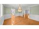 Elegant living room with hardwood floors, wainscoting, and view to updated kitchen at 2592 Westminster Ter, Oviedo, FL 32765