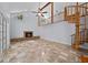 Spacious living room showcasing a brick fireplace, high ceilings, and a unique spiral staircase at 2592 Westminster Ter, Oviedo, FL 32765