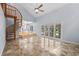 Bright living room features marble floors, spiral staircase, vaulted ceilings and sliding glass doors to the pool at 2592 Westminster Ter, Oviedo, FL 32765