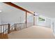 Upstairs loft area with carpet flooring, wood beam accents, and a ceiling fan at 2592 Westminster Ter, Oviedo, FL 32765
