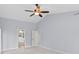 Spacious main bedroom with ceiling fan, vaulted ceiling, light blue walls, and ensuite bathroom at 2592 Westminster Ter, Oviedo, FL 32765