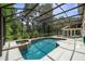 Screened-in pool and spa offer a private outdoor retreat with lush landscaping at 2592 Westminster Ter, Oviedo, FL 32765