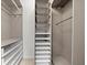 Custom walk-in closet with built-in shelving, drawers, and hanging rods for organized storage at 2592 Westminster Ter, Oviedo, FL 32765