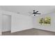 Simple bedroom with wood-look floors, a ceiling fan, and a window with a view of trees at 2601 Telstar Ave, Orlando, FL 32805