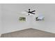 Neutral bedroom with wood-look flooring, ceiling fan, and window showing natural light at 2601 Telstar Ave, Orlando, FL 32805