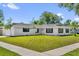 Charming single-story home with a well-maintained lawn and fresh white exterior paint at 2601 Telstar Ave, Orlando, FL 32805