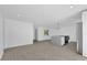 Bright, open-concept living space with neutral flooring, recessed lighting, and white walls at 2601 Telstar Ave, Orlando, FL 32805