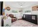 Bright bedroom with a comfortable chair, crib, and stylish decor at 2926 Carriage Dr, South Daytona, FL 32119