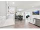 Open floor plan with kitchen bar and dining area, seamlessly connecting to a bright office space in the background at 2926 Carriage Dr, South Daytona, FL 32119
