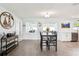 Bright dining area featuring wood-look tile flooring, modern lighting, and an open layout perfect for entertaining at 2926 Carriage Dr, South Daytona, FL 32119