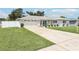 Beautifully renovated home with a large front lawn, spacious driveway, and two car garage at 2926 Carriage Dr, South Daytona, FL 32119