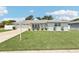 Attractive single-story home with a well-maintained lawn, inviting front porch and a two car garage at 2926 Carriage Dr, South Daytona, FL 32119