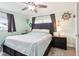 Cozy primary bedroom with soft green walls, wood-look tile floors, and coastal-themed decor accents at 2926 Carriage Dr, South Daytona, FL 32119