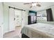 Comfortable primary bedroom featuring a view to the ensuite bathroom through sliding barn doors, enhancing privacy at 2926 Carriage Dr, South Daytona, FL 32119