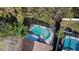 Birds eye view of backyard pool area and surrounding mature foliage at 3013 Barrymore Ct, Orlando, FL 32835
