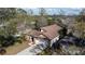 Aerial view of a well-maintained home with a spacious driveway and lush landscaping at 3013 Barrymore Ct, Orlando, FL 32835