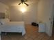 Simple bedroom featuring tile floors, a ceiling fan, and a large bed with white linens at 3013 Barrymore Ct, Orlando, FL 32835