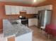Updated kitchen featuring stainless steel appliances, granite counters, and white cabinets at 3013 Barrymore Ct, Orlando, FL 32835