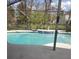 Inviting swimming pool surrounded by a screened enclosure and lush landscaping at 3013 Barrymore Ct, Orlando, FL 32835