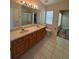 Bathroom features dual sinks, neutral tile flooring and modern fixtures at 3807 Plantation Blvd, Leesburg, FL 34748