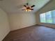 Spacious bedroom featuring neutral walls, ceiling fan and a window allowing natural light at 3807 Plantation Blvd, Leesburg, FL 34748
